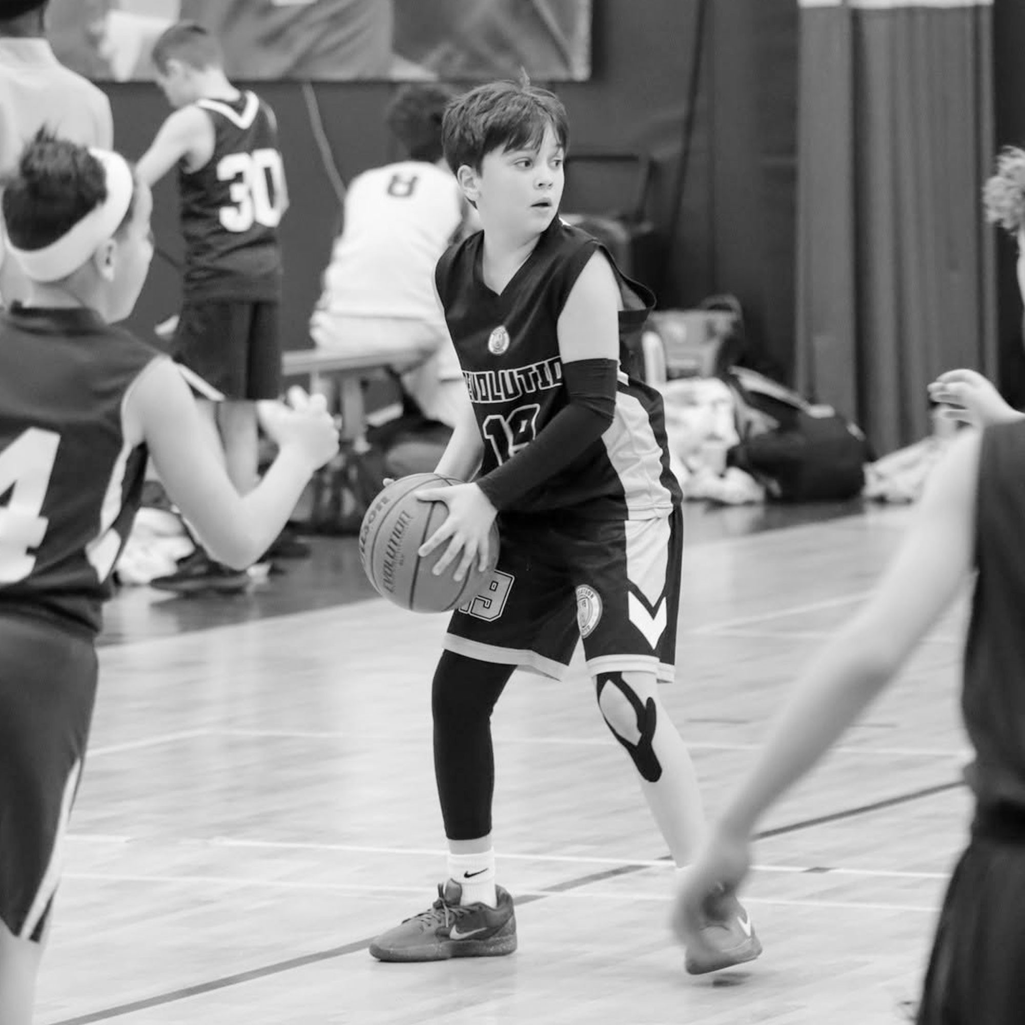 Youth travel basketball player driving to the hoop